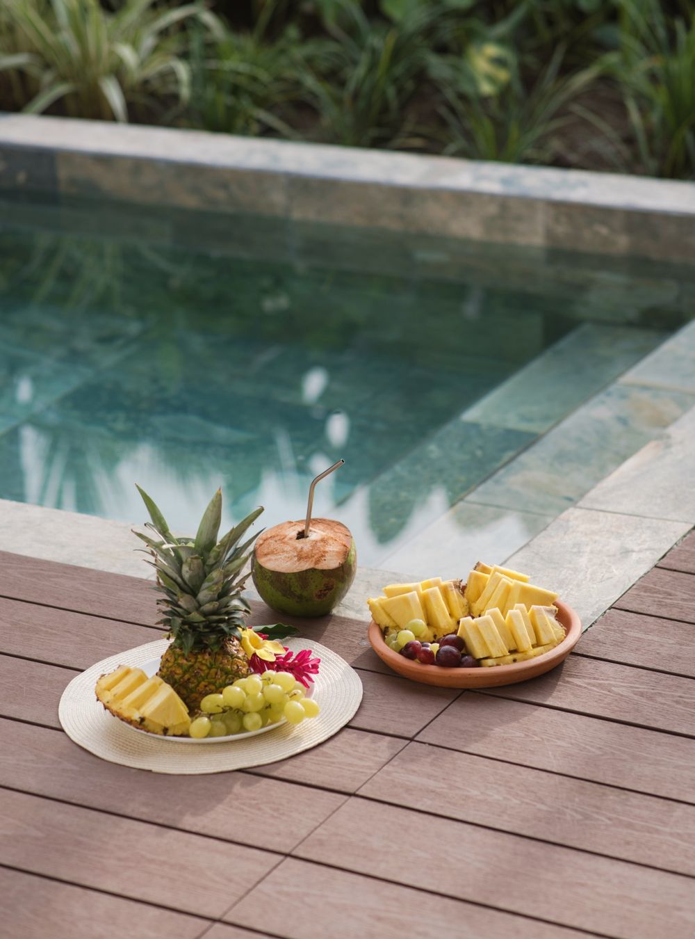 Fresh pineapple, grapes and a coconut by the pool
